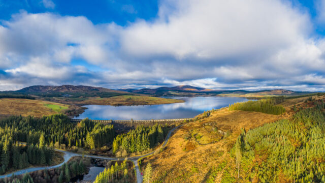 Aerial view of a sweeping valley with a large lake