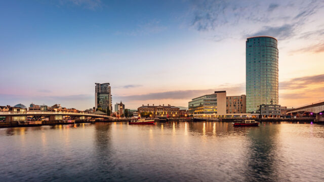 City skyline on water at sunset