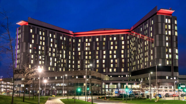 A large hospital building lit up at night
