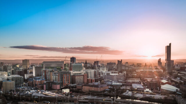 City with brick buildings and skyscraper at sunrise