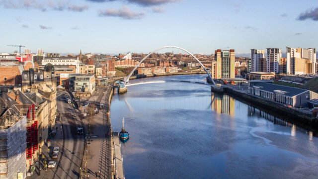River flowing through city with building lined streets on each side