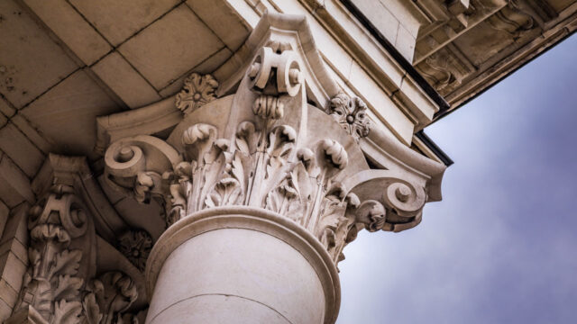 A close up image of the corner of a stone pillar