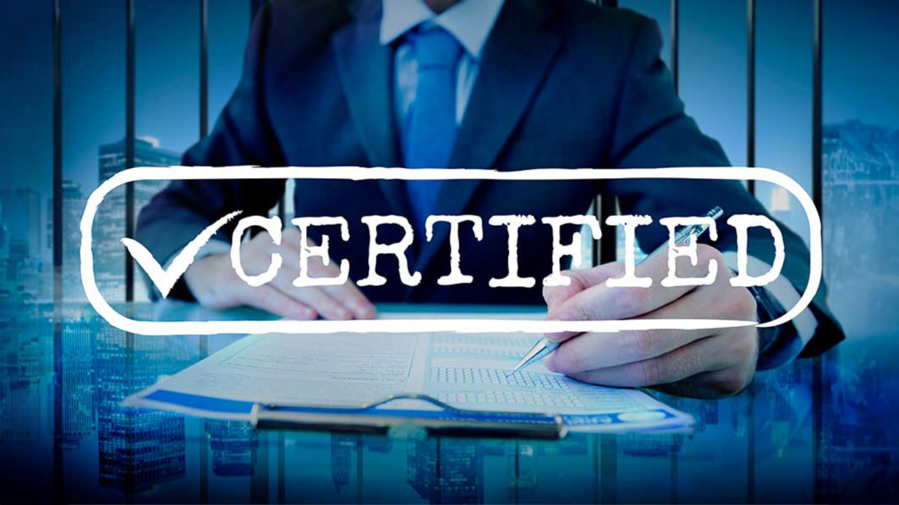 A person in a suit is signing a document with a pen, overlaid with the word "CERTIFIED" and a checkmark graphic.