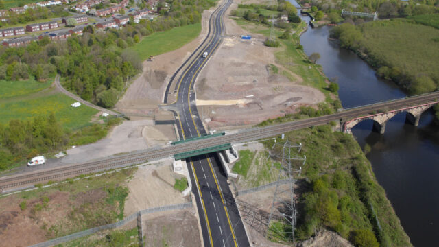 Aerial view of the Wakefield Eastern Relief Road - featuring a new road and railway bridge over a river, surrounded by greenery and residential areas.