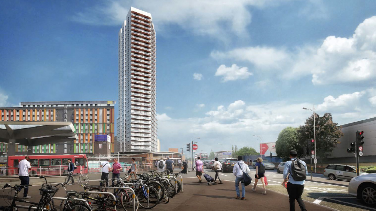 A very tall building in Hale village towering high above other buildings and streets of a bustling community