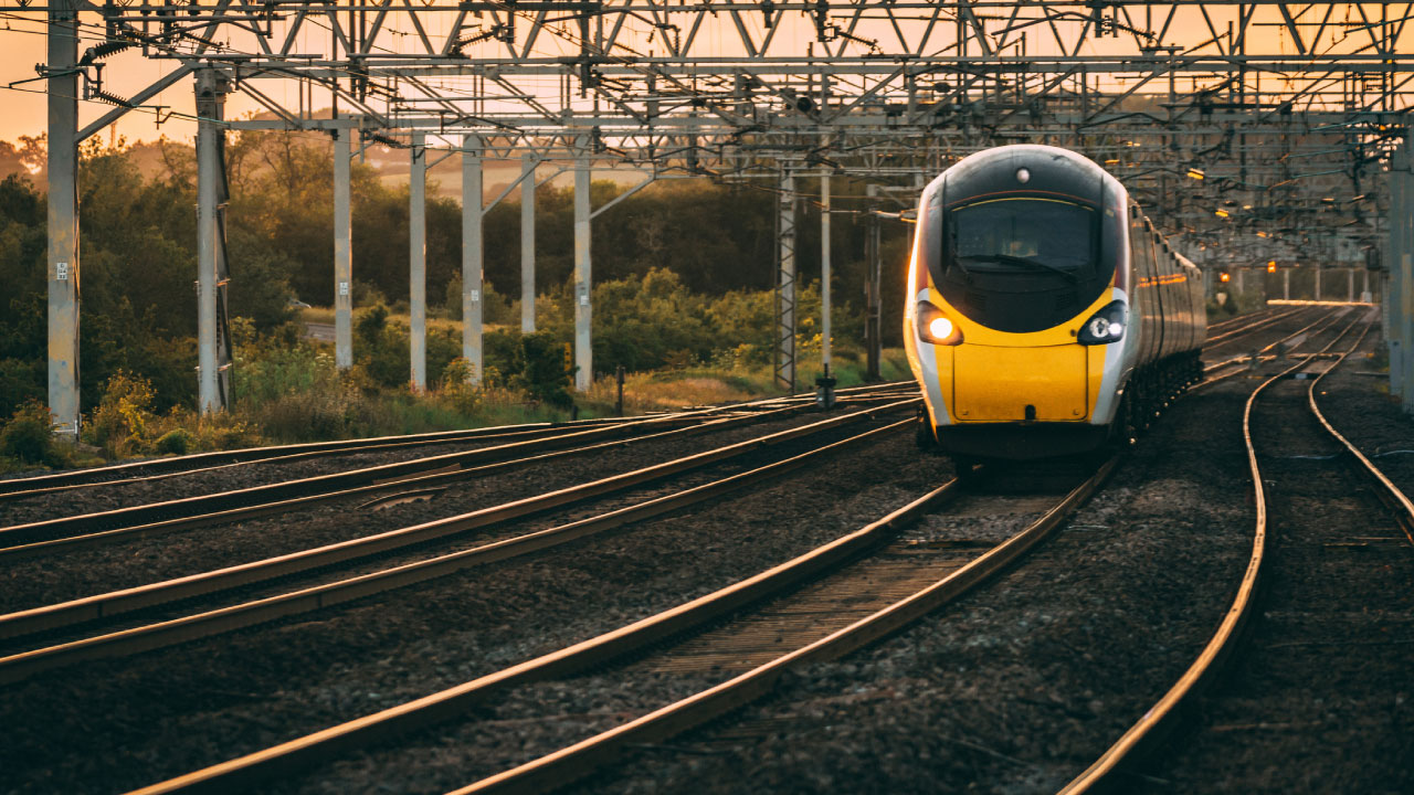 A modern yellow train on rails
