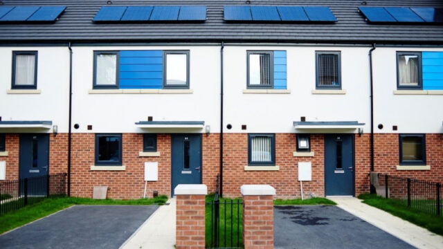 Front view of multiplex housing with solar panels on the roof
