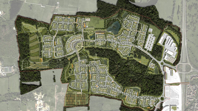A bird's eye view of an urban area with greenery and connecting roads