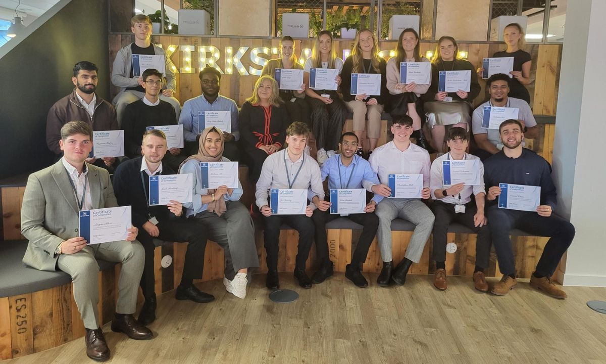 Tetra Tech Early Careers Graduates sat together with their certificates - A group photo of individuals holding certificates, smiling.