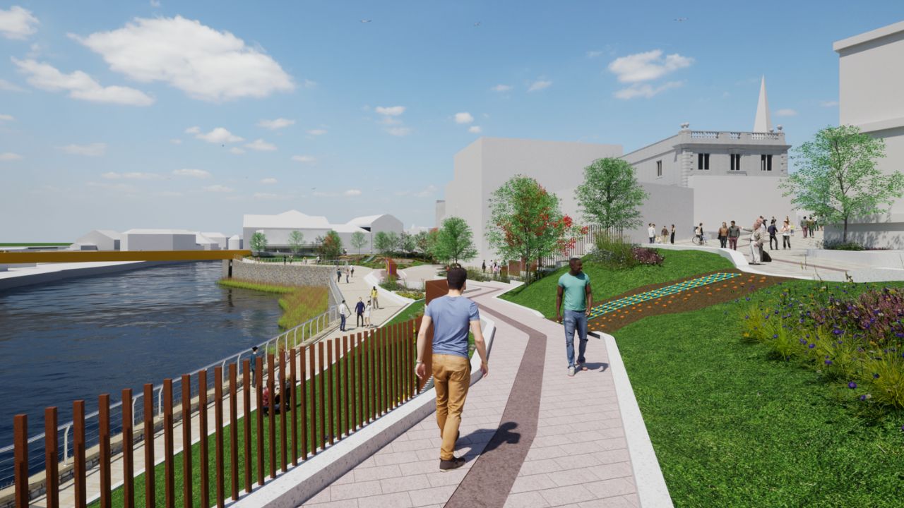 A digital rendering of a riverside park with walking paths, green lawns, trees, and people strolling along the waterfront under a blue sky with scattered clouds.