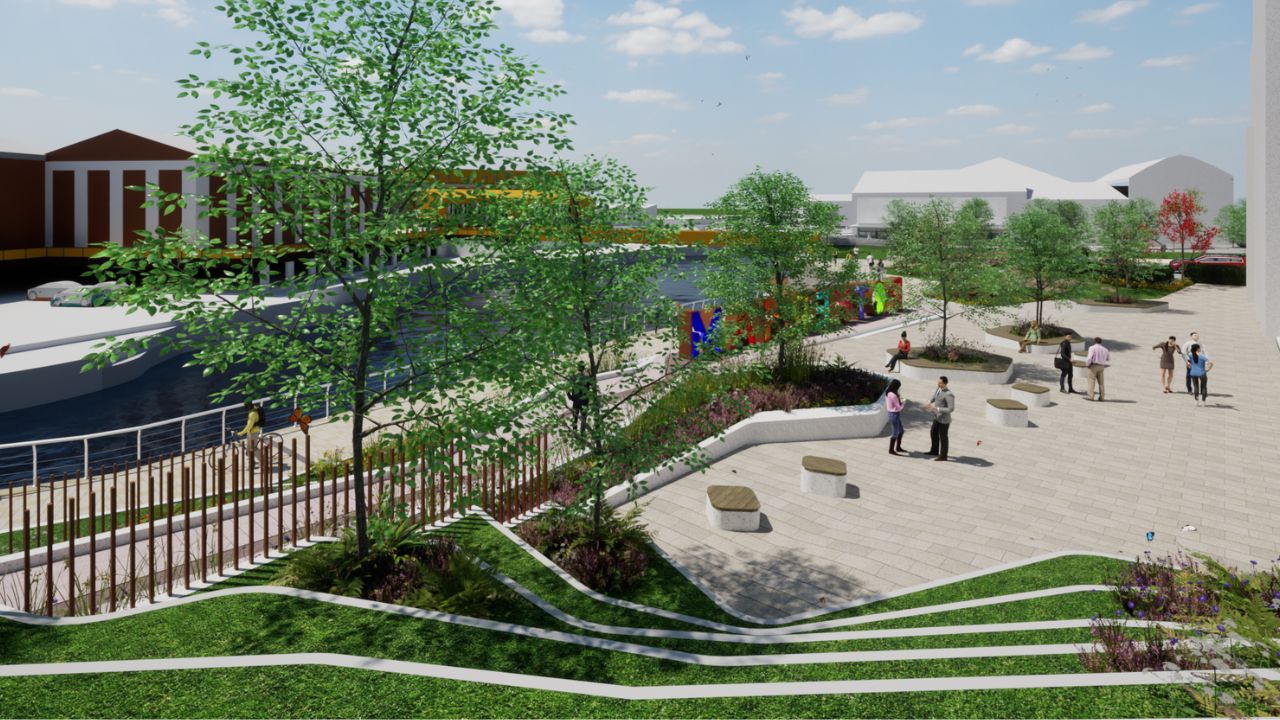 A digital rendering of a riverside urban park with paved walkways, green grassy terraces, trees, benches, people walking and socializing, and colourful letters spelling "Rotherham" near the water.