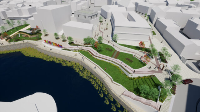 A 3D architectural rendering of a riverside urban park with winding walking paths, green lawns, trees, and a colourful "Rotherham" sign along the waterfront, surrounded by modern buildings.
